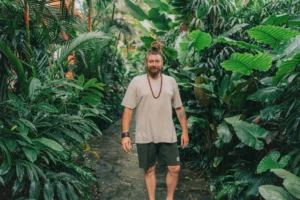 Chenzo walking along a narrow jungle garden path in Bali