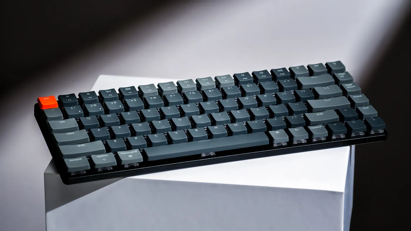 Keychron K3 low-profile mechanical keyboard on a white block, angled to show the thin switches