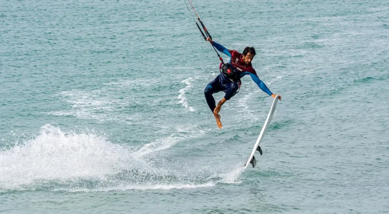 Kitesurfer with a strapless board jumping over the water at Playa de Los Lances, Tarifa