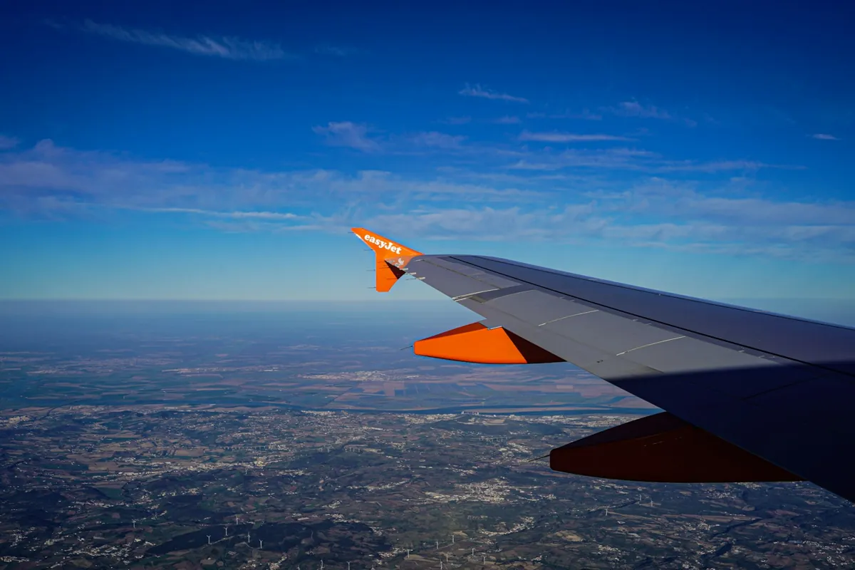 Airplane wing over a city on approach to Lisbon airport