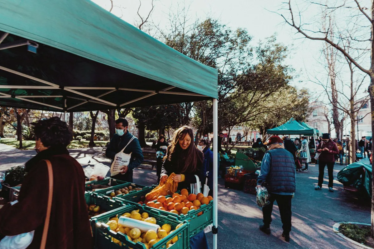 Shoppers at a fruit stand at a Lisbon market