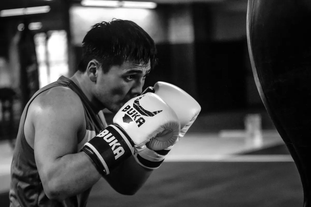 Man wearing boxing gloves in a gym