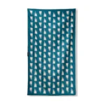 Nomadix Ultralight towel with a teal and white pattern, laid flat