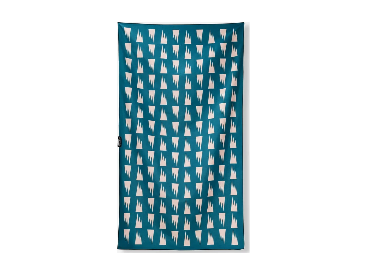 Nomadix Ultralight towel with a teal and white pattern, laid flat