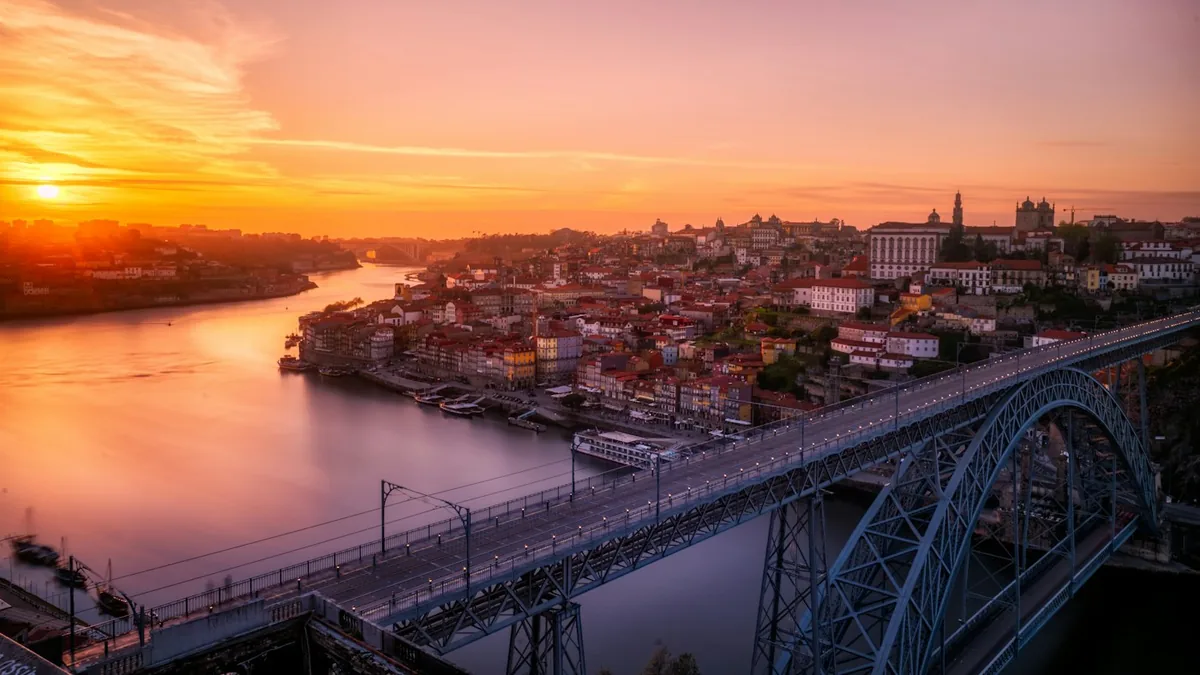 Sunset sky over the Douro river and a steel arch bridge in Porto, Portugal