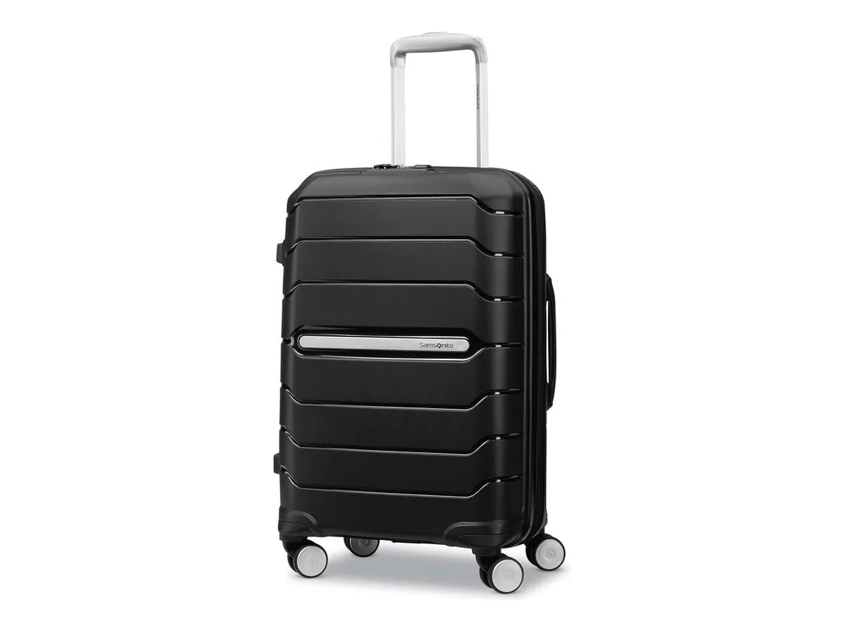 Black Samsonite Freeform hardside carry-on spinner with a silver handle, horizontal ridges and four wheels