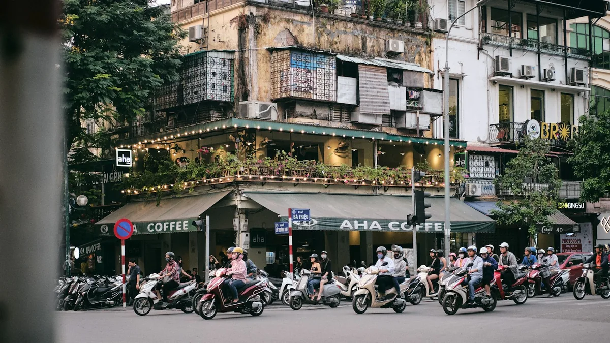 Row of scooters at a cafe corner in Hanoi, scooter rental in Vietnam