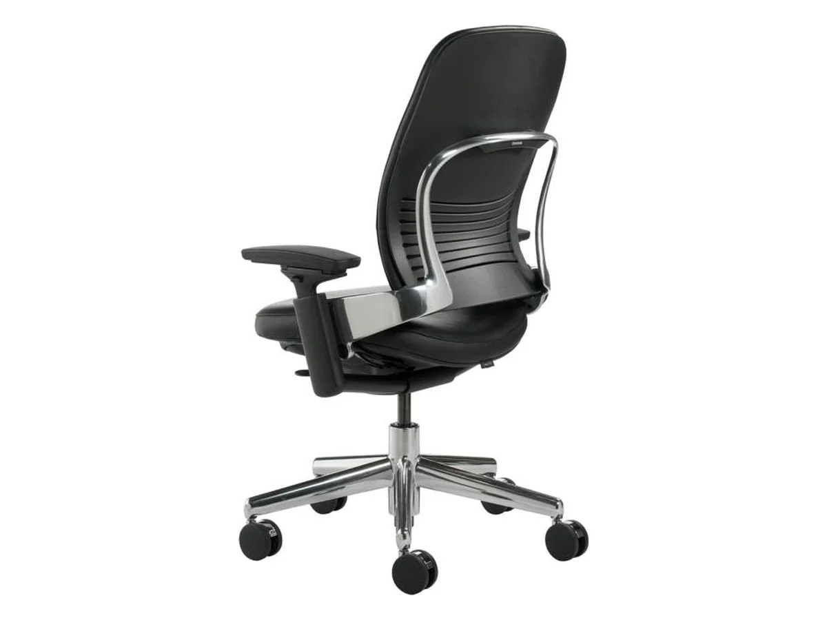 Black Steelcase Leap office chair with adjustable arms and a polished aluminum base, seen from behind