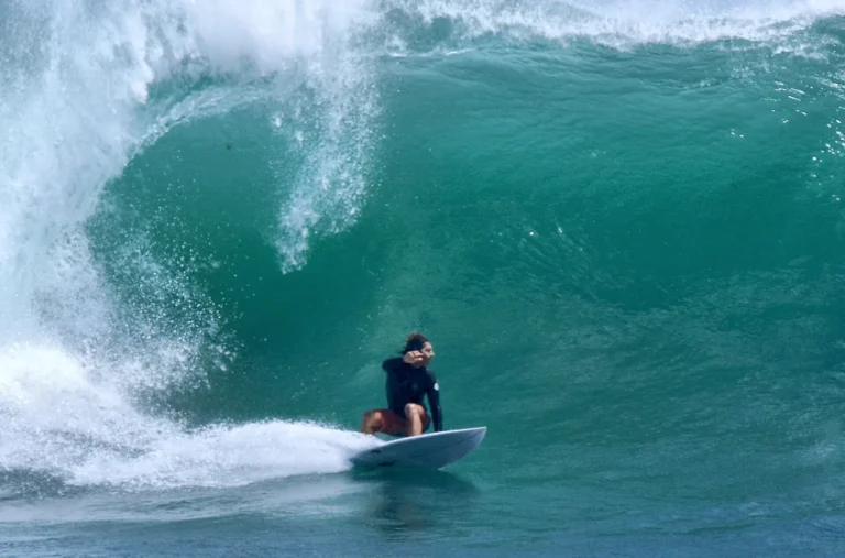 Surfer inside a green barrel wave at Uluwatu, Bali
