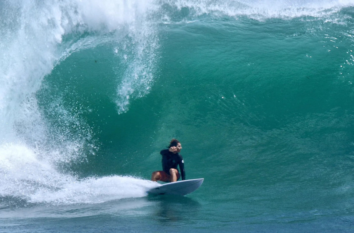 Surfer inside a green barrel wave at Uluwatu, Bali