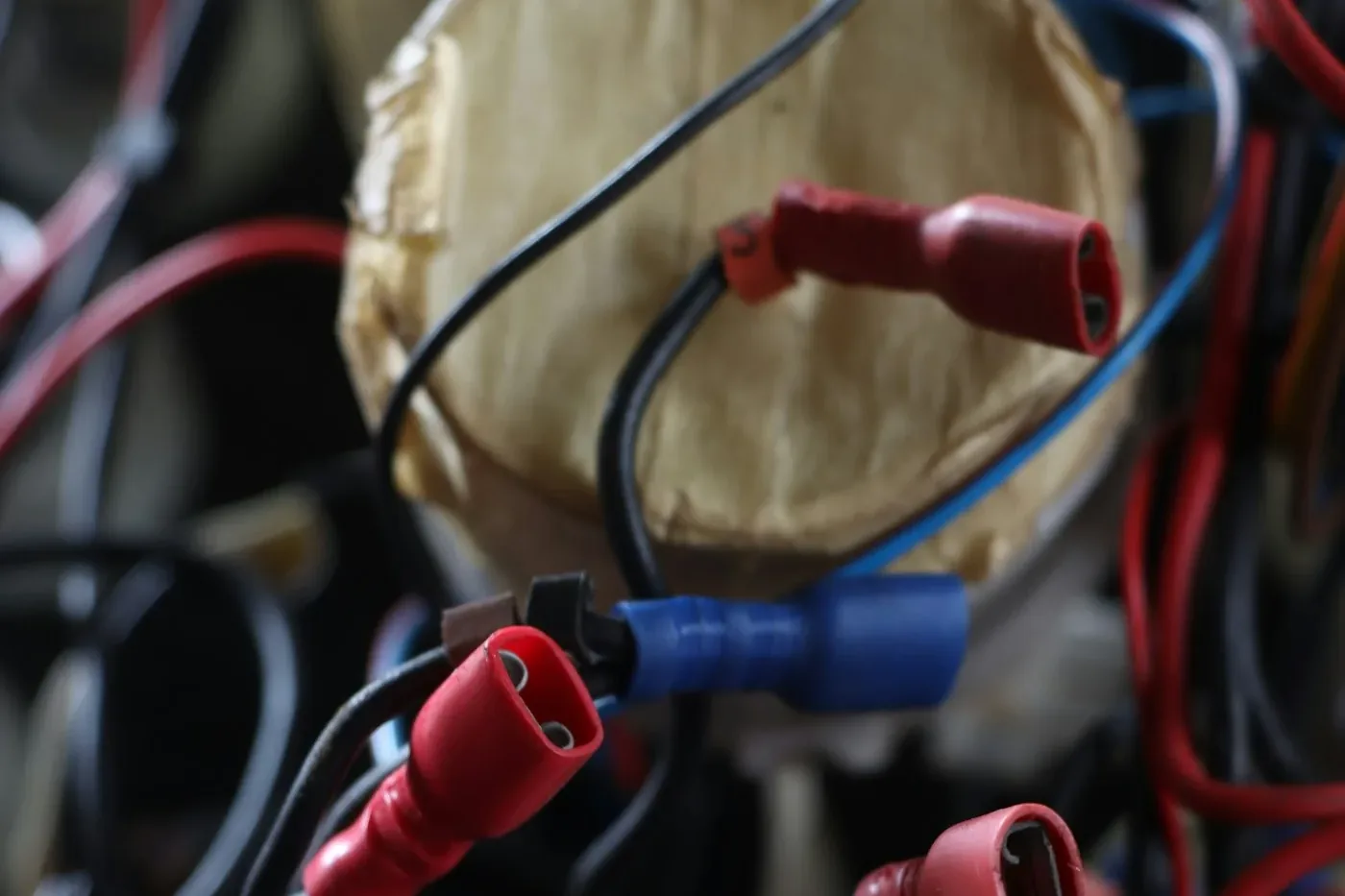 Tangled black, red and blue wires with red and blue crimp connectors